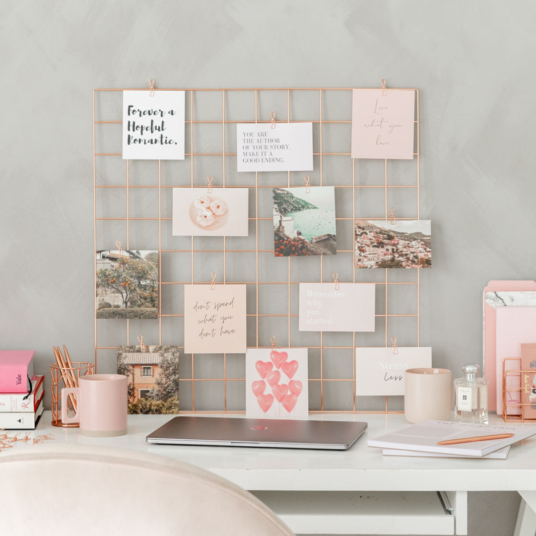 Vision board on a desk with vision board cards scattered