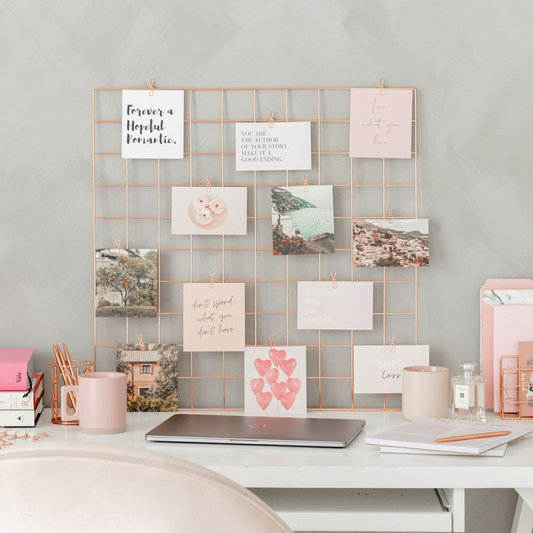 Vision board on a desk with vision board cards scattered