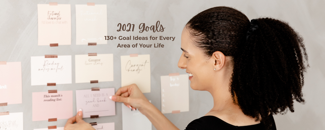 Vision board cards being tapped to wall with text that reads "2027 Goals: 130+ Goal Ideas for Every Area of Your Life".