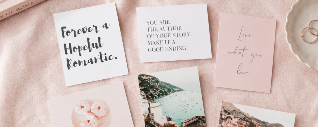 Vision board cards spread on a blush table
