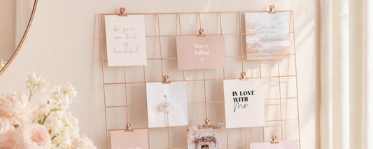 Vision board on a rose gold grid perched on a desk