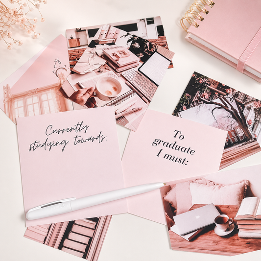 Study Vision Board Cards arranged on a desk with a pink notebook