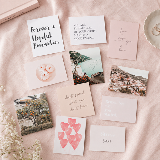 Vision board cards spread on a blush table