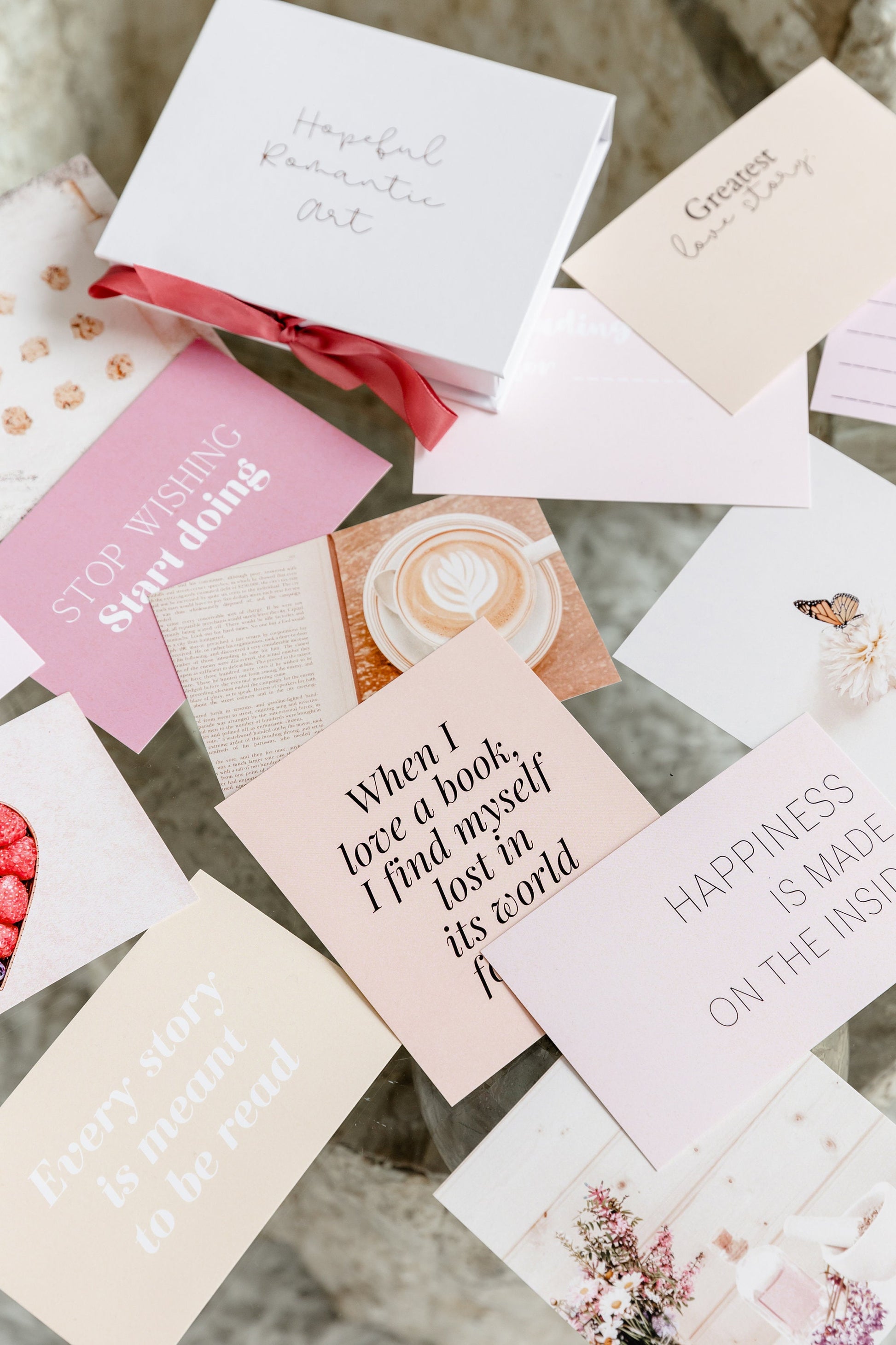 Aesthetic vision board cards displayed on a bright desk with a rose gold grid