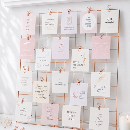 Affirmation cards displayed on rose gold vision board grid