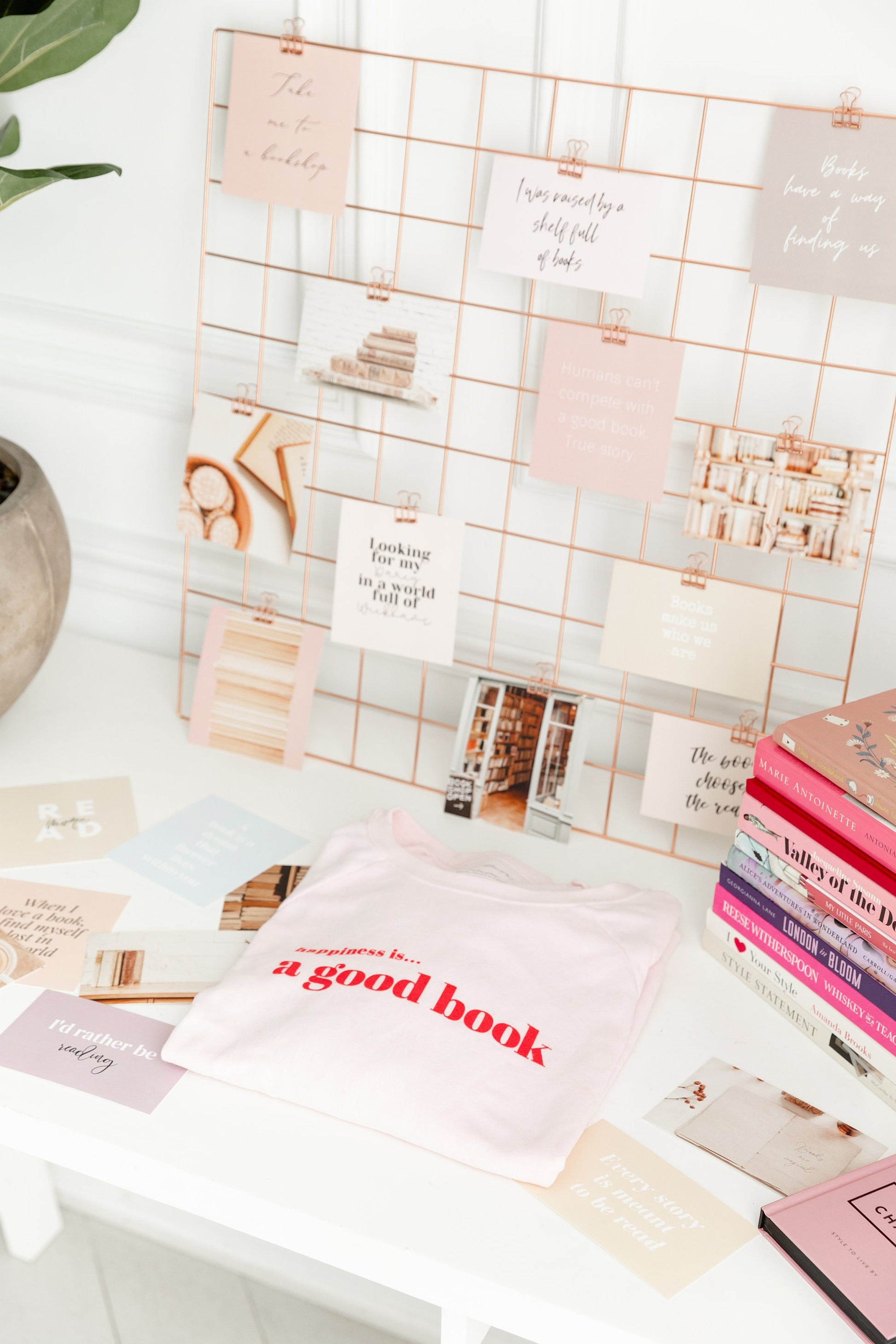 Bookish vision board cards displayed on a desk with books, clips, and stationery