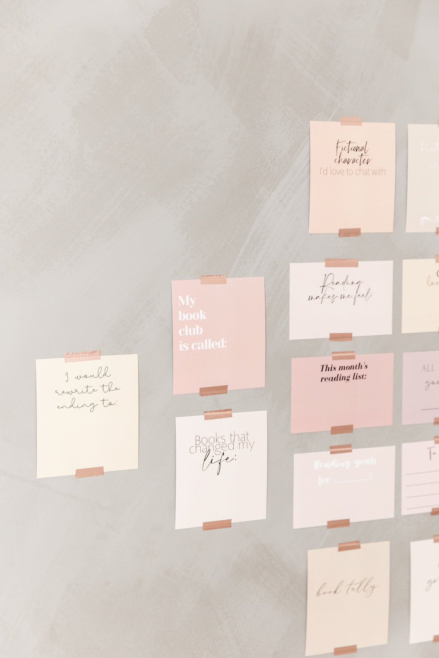 Bookish vision board cards displayed on a wall with soft pink and neutral cards