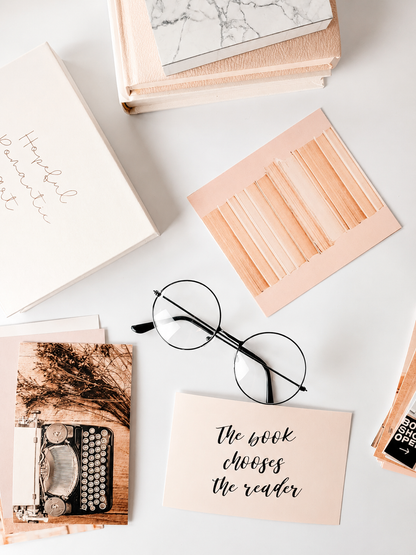 Bookish vision board cards styled with rose gold clips and reading-themed cards