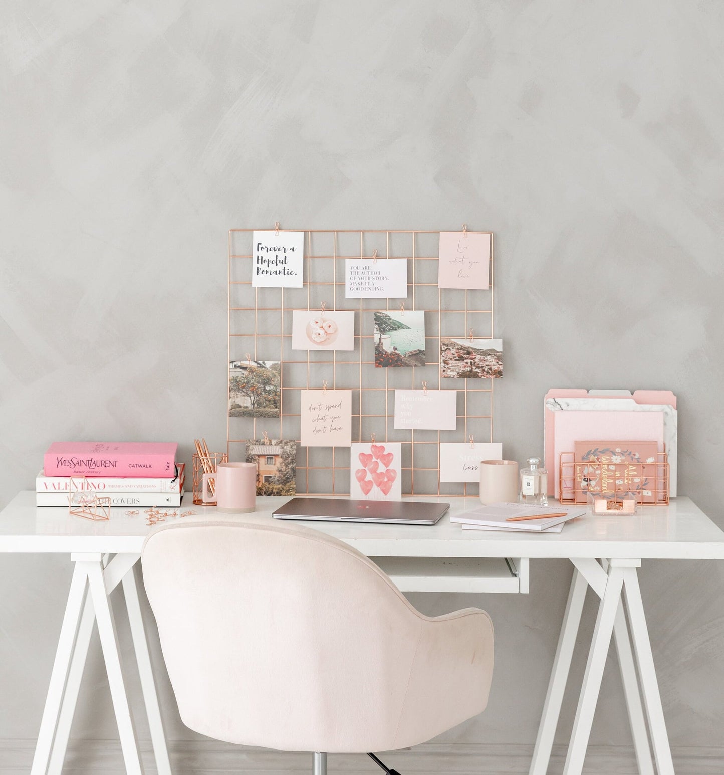 Rose gold wire grid mounted on wall as vision board display