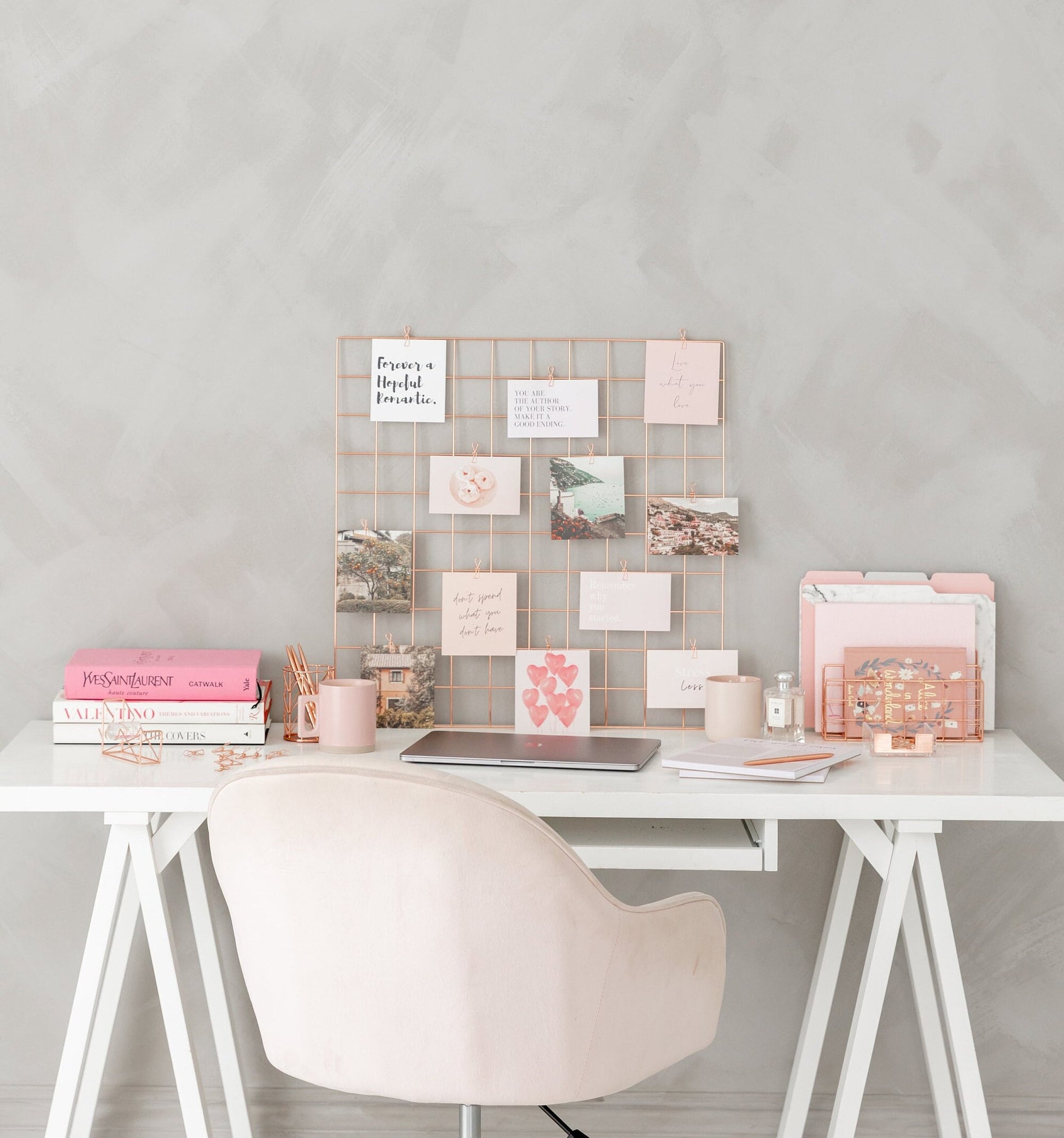Rose gold wire grid mounted on wall as vision board display