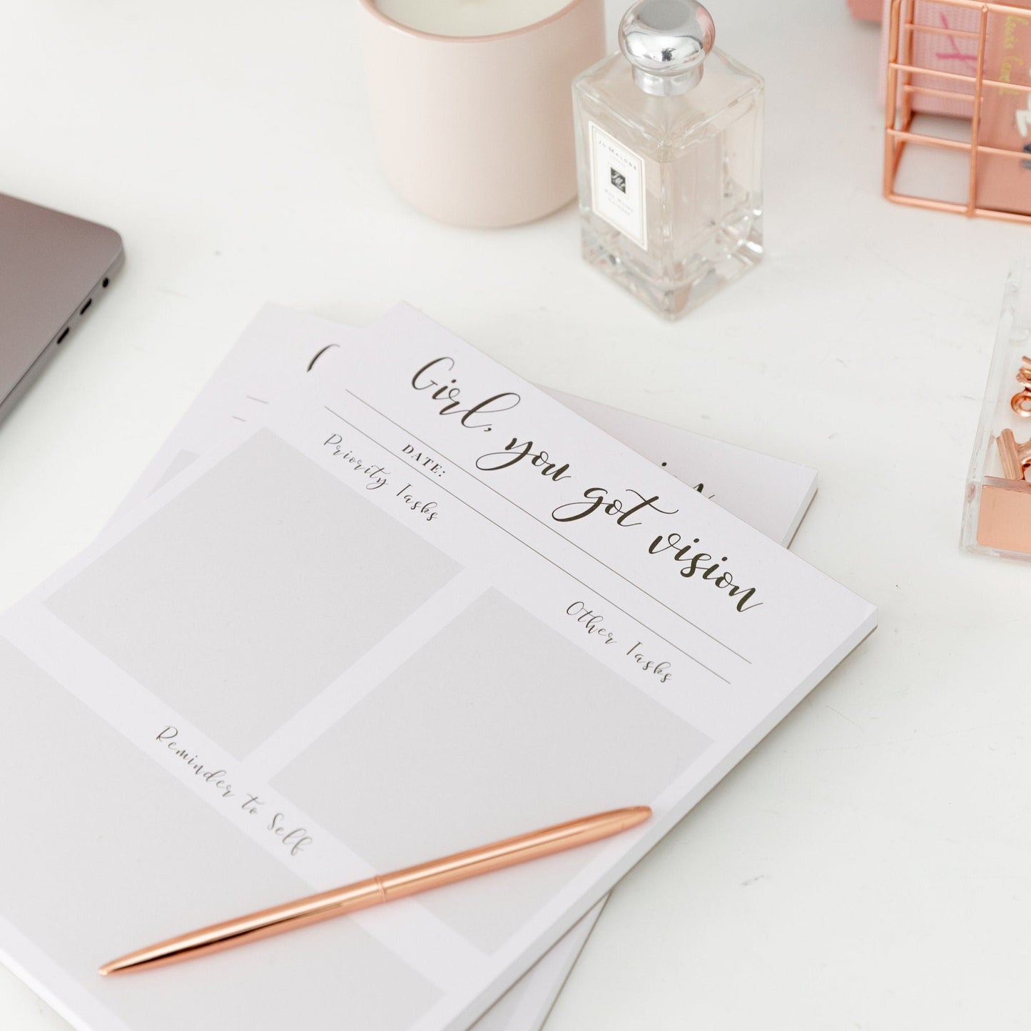 8x10 daily planner notepad styled on a bright desk with a pen and stationery accessories