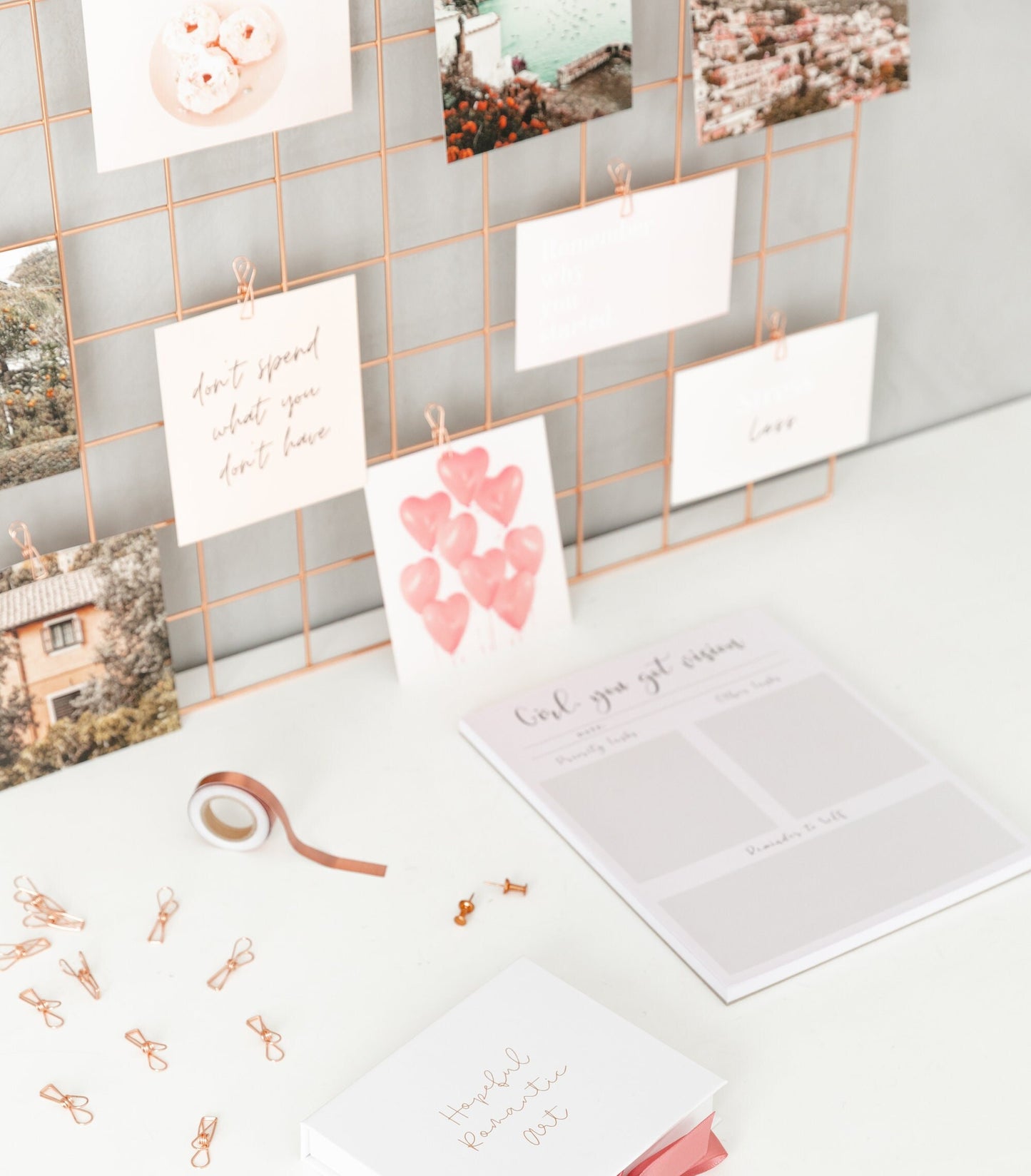 Daily planner notepad styled with vision board cards on a wall grid