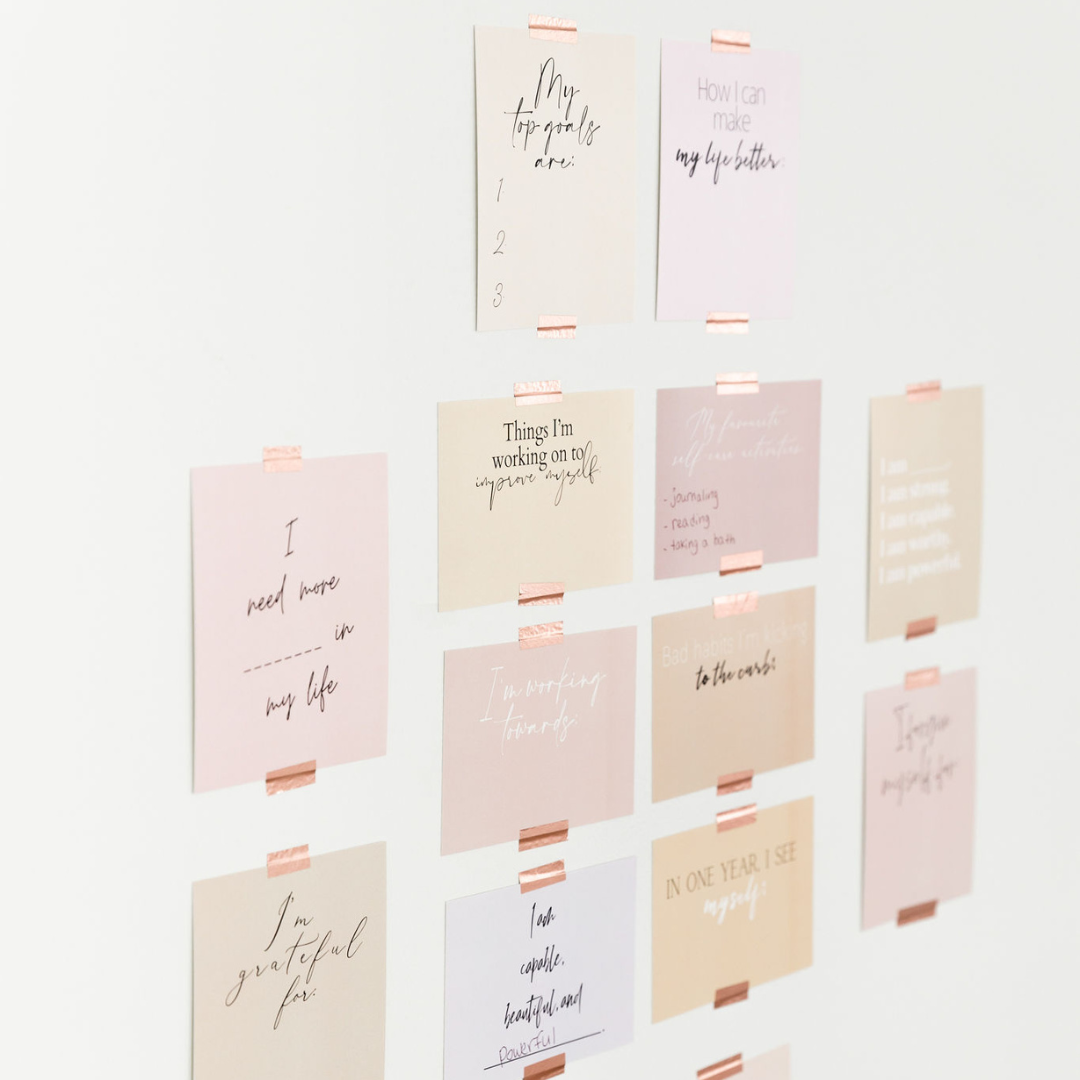 Goal setting vision board cards taped onto wall