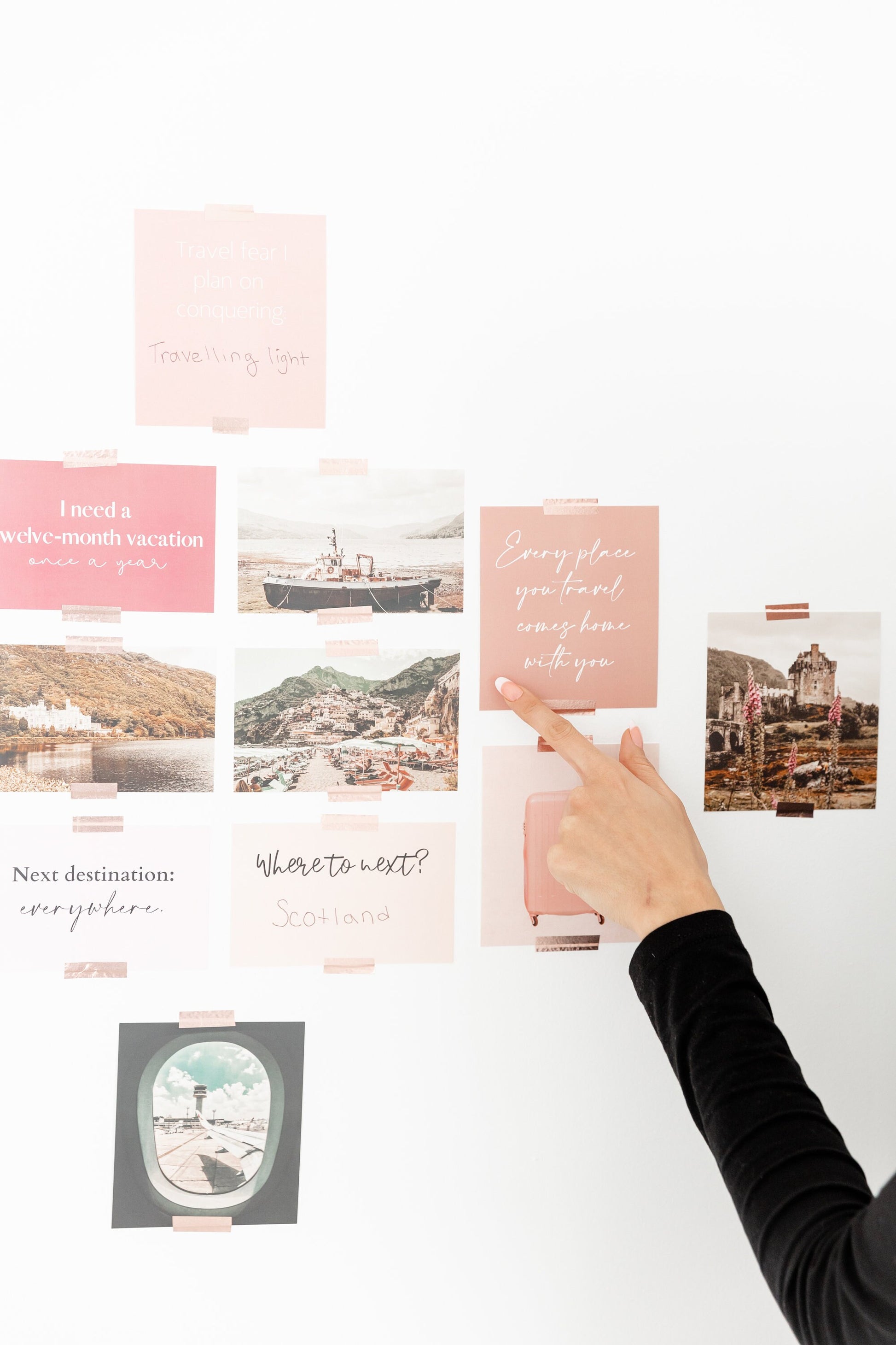 Person arranging travel cards on a white surface