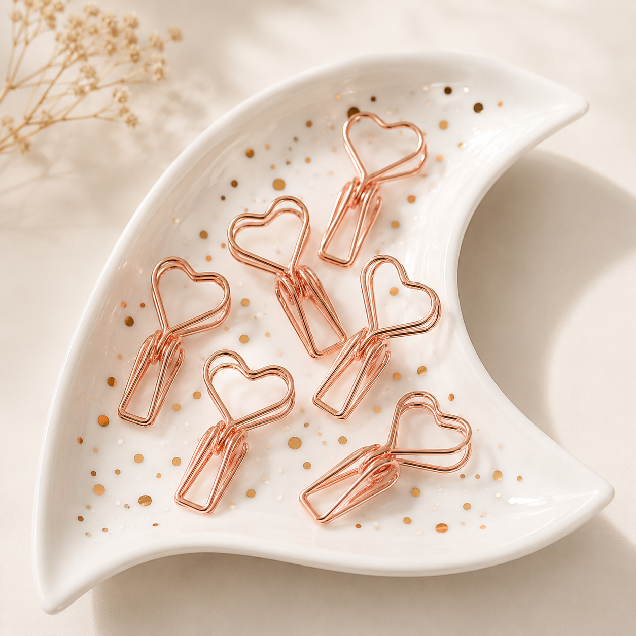 Rose gold heart clips in white crescent moon trinket dish with gold flecks