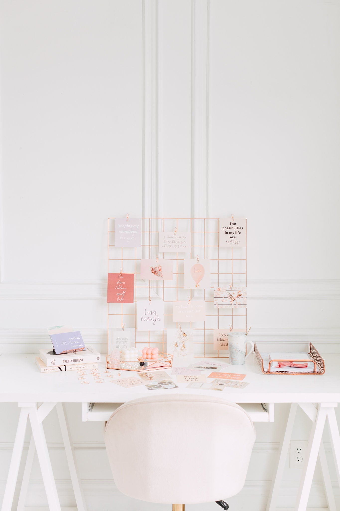Manifestation vision board cards clipped to a wall grid for daily inspiration