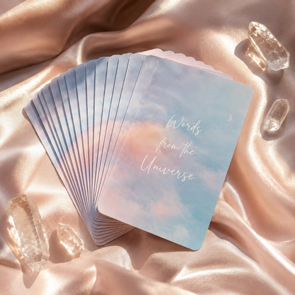 Oracle card reading cards fanned out on satin with clear quartz crystals