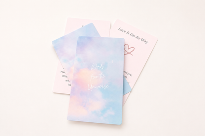 Three pastel oracle cards arranged on a soft blush background