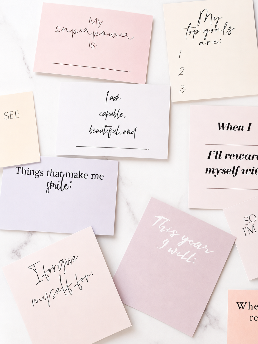 Pink and neutral positive affirmation cards layered together in a soft flat-lay arrangement.