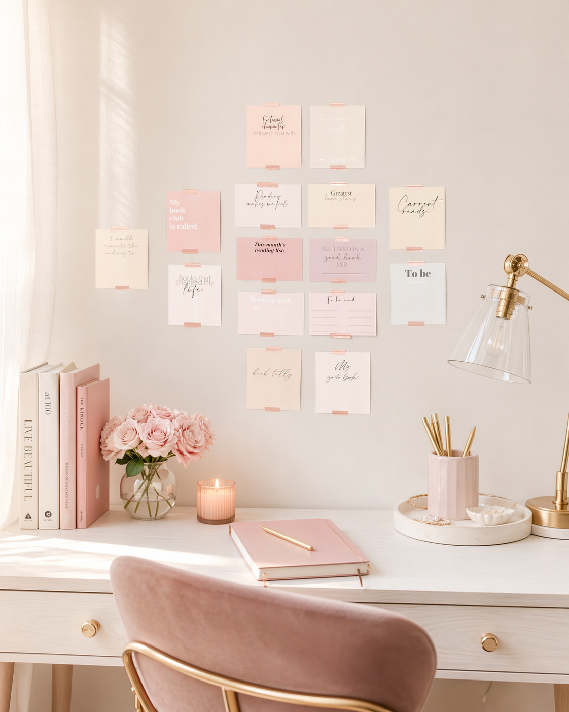 Pastel reading tracker card set displayed above a feminine desk with books, flowers, a candle and pink stationery.