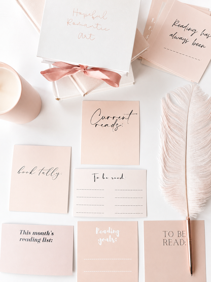Stack of reading tracker cards with fill-in-the-blank book log designs