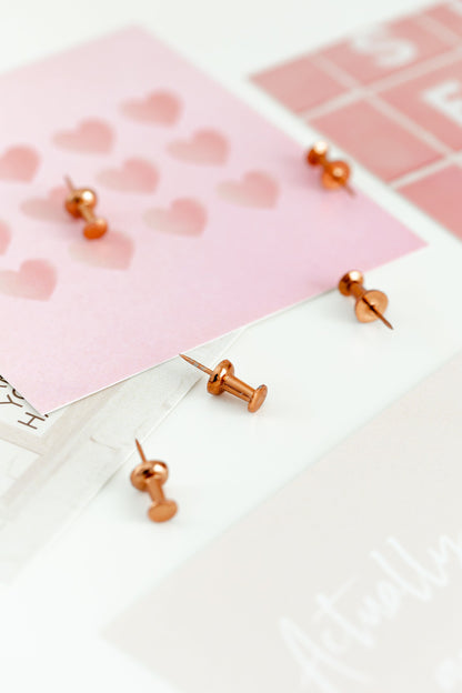 Rose gold clips and wall grid accessories styled on a bright desk