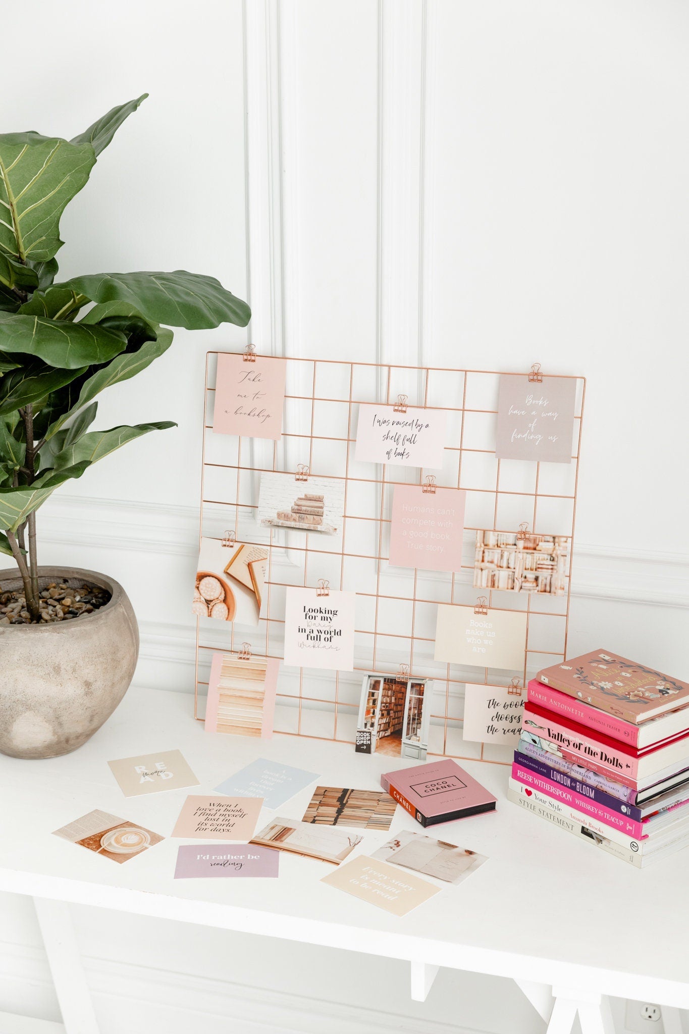 Rose gold binder clips styled with vision board cards and desk accessories
