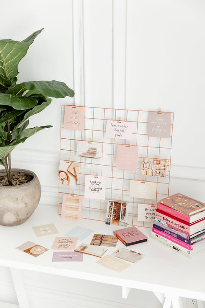 Rose gold binder clips styled with vision board cards and desk accessories