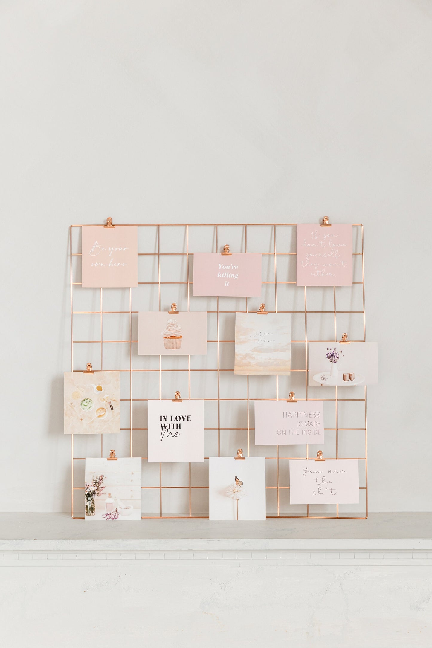 Rose gold wall grid with vision board cards clipped on display