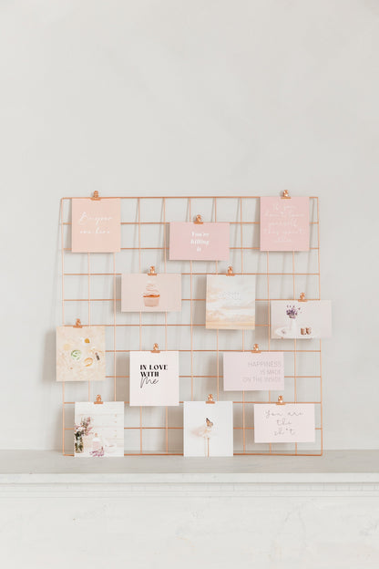 Rose gold wall grid with vision board cards clipped on display
