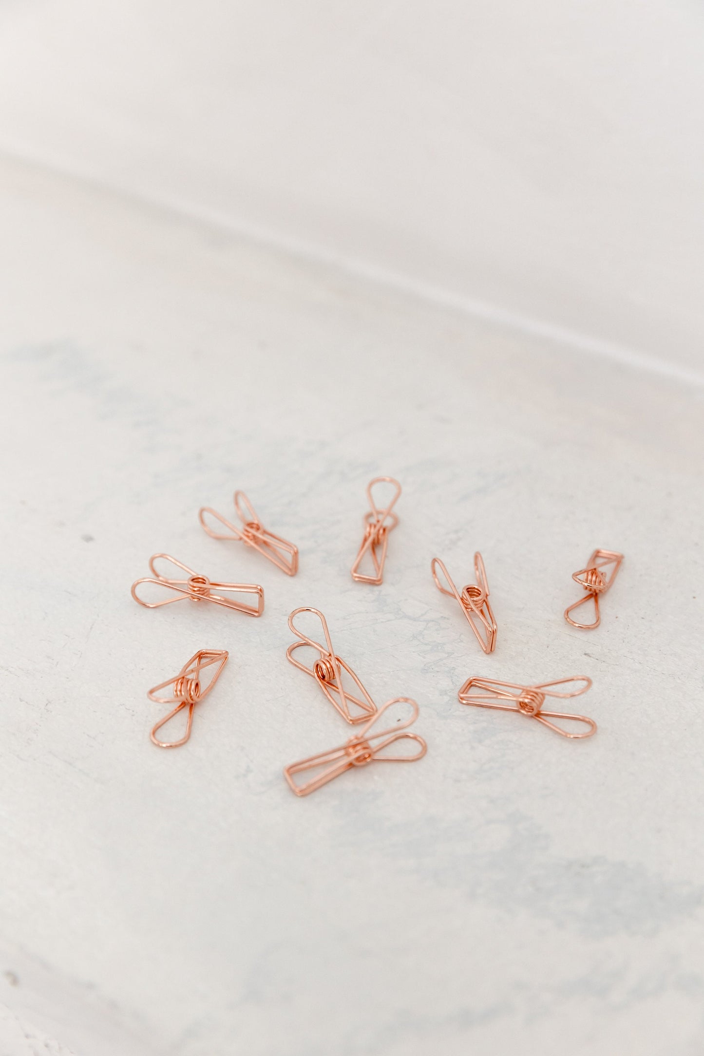 Close-up of rose gold wire clips for photos, notes, and vision board cards