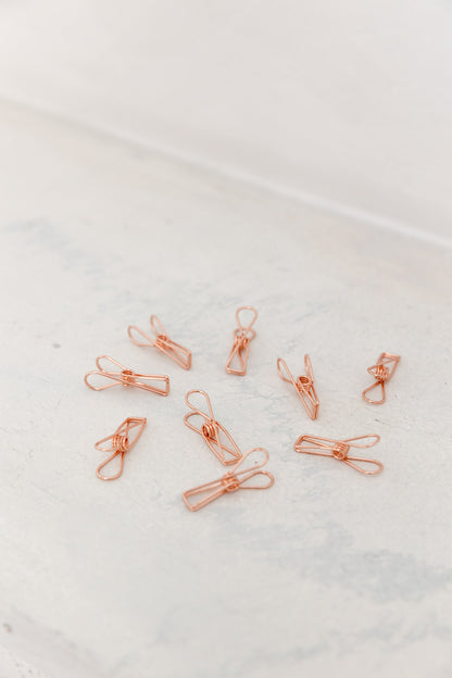 Close-up of rose gold wire clips for photos, notes, and vision board cards