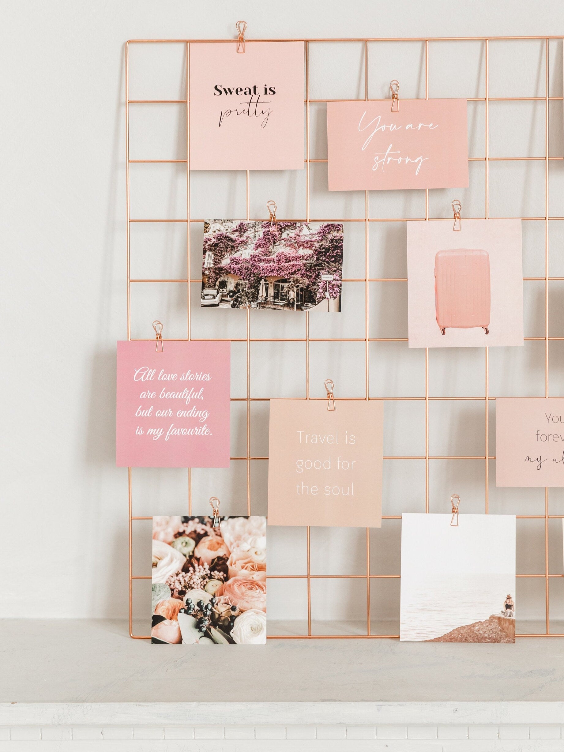 Full wall grid display with rose gold wire clips, cards, and photos