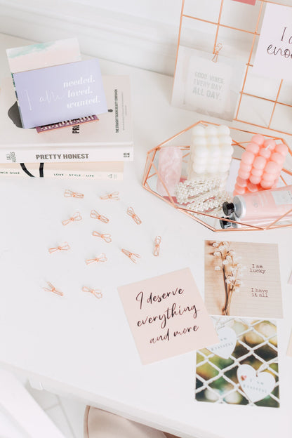 Rose gold wire clips styled with mood board cards and creative desk decor