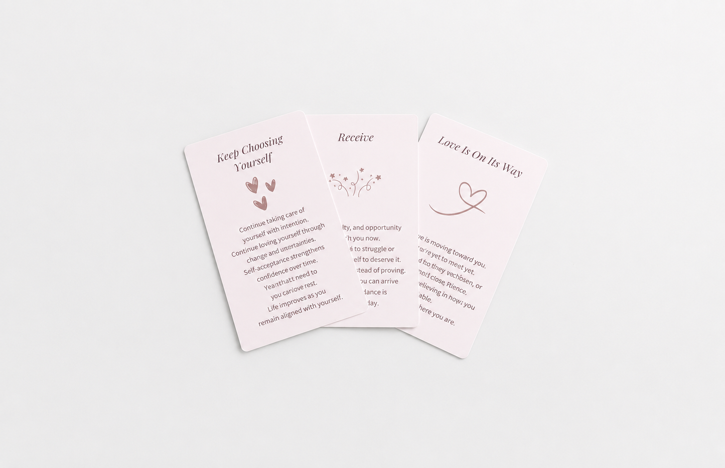Three pastel oracle cards featuring messages about self-worth, receiving support and love, arranged on a soft white background