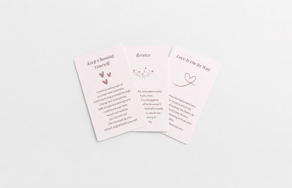Three pastel oracle cards featuring messages about self-worth, receiving support and love, arranged on a soft white background