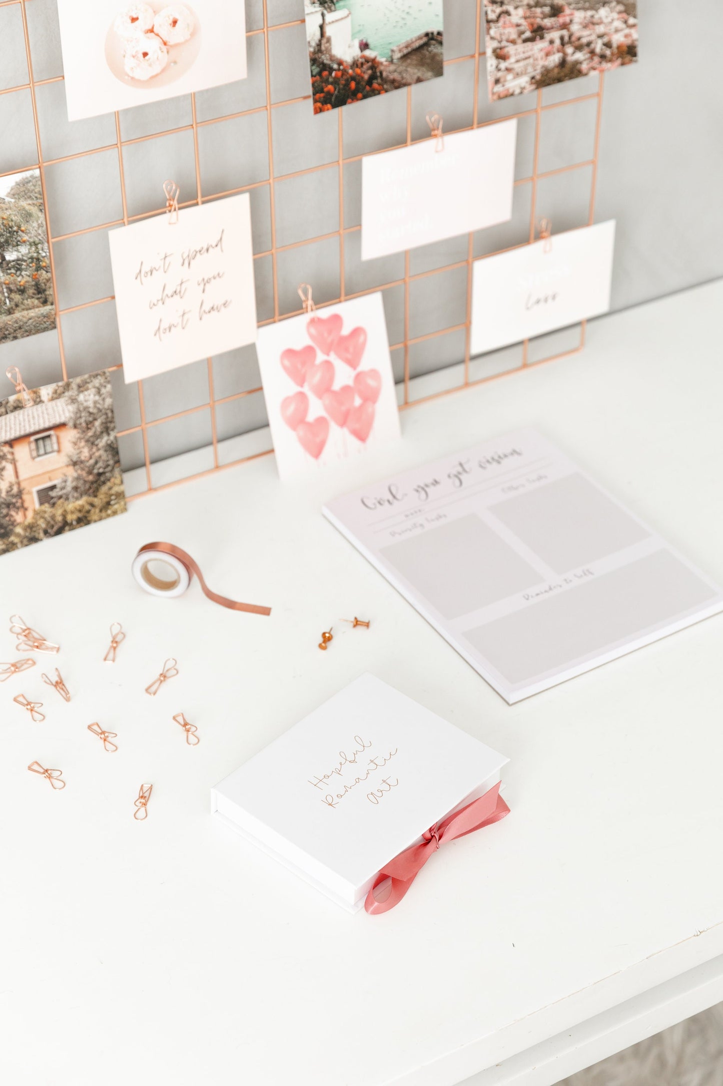 Vision board kit displayed on bedroom wall with photos and affirmations