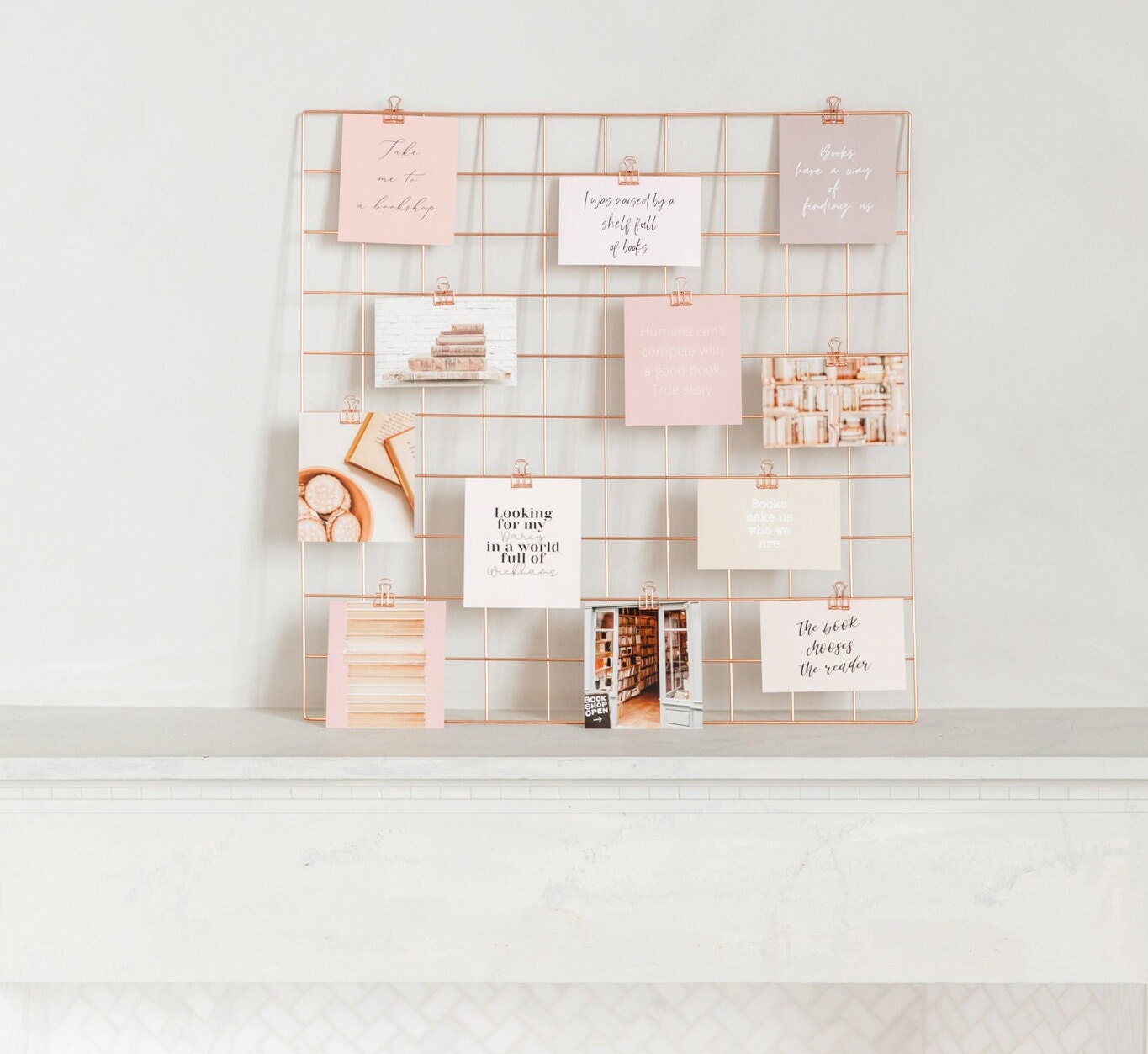 Vision board wall grid styled with rose gold clips and inspiration cards