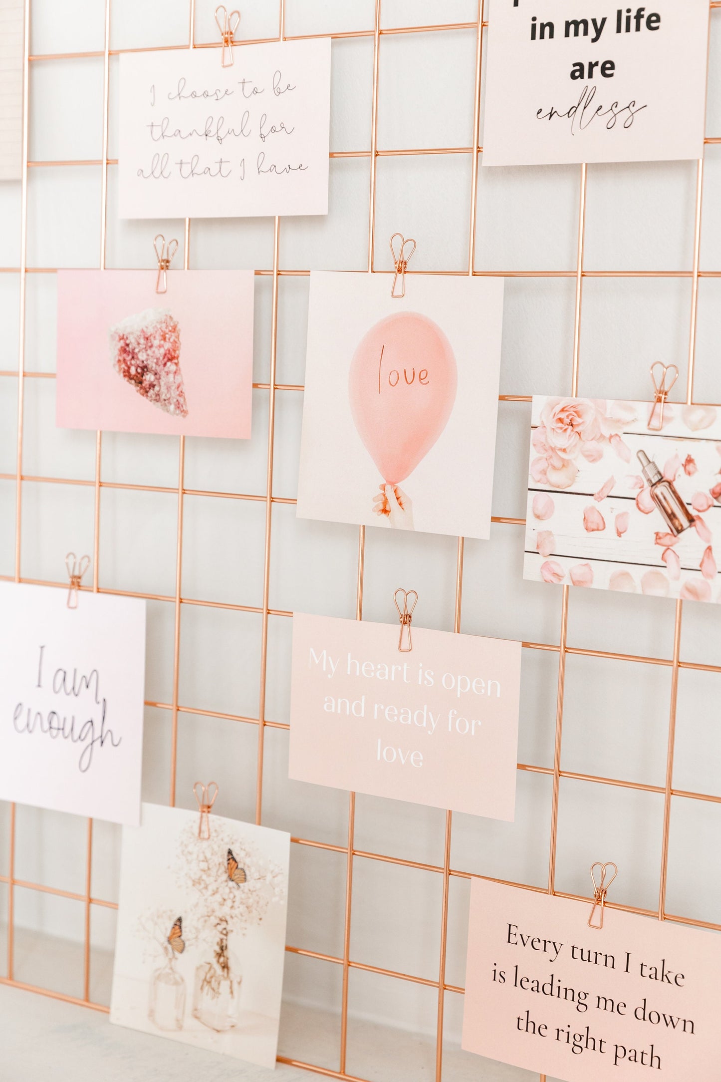 Wall grid styled with rose gold wire clips and inspirational cards